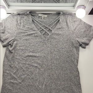 Knitted grey shirt, opening with cross pattern